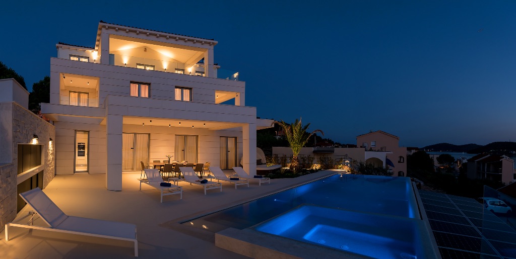 Villa at night with illuminated pool